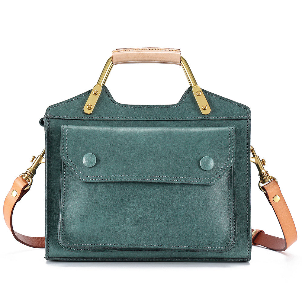 Green handbag with gold accents on a white background