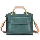 Green handbag with gold accents on a white background