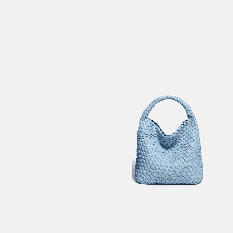 Light blue woven handbag on a light gray background