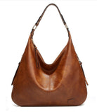 Brown leather handbag on a white background