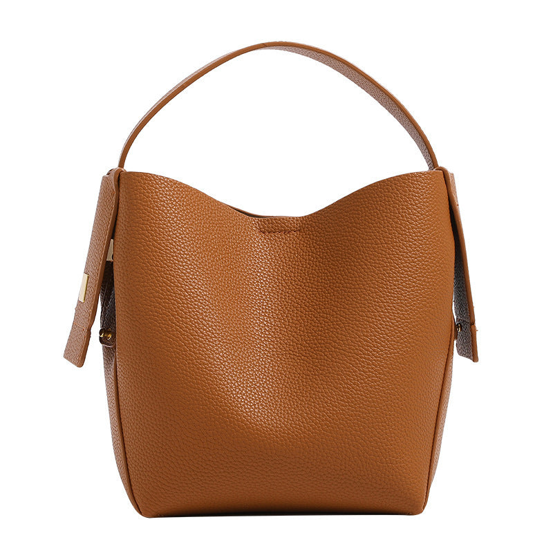 Brown leather handbag on a white background