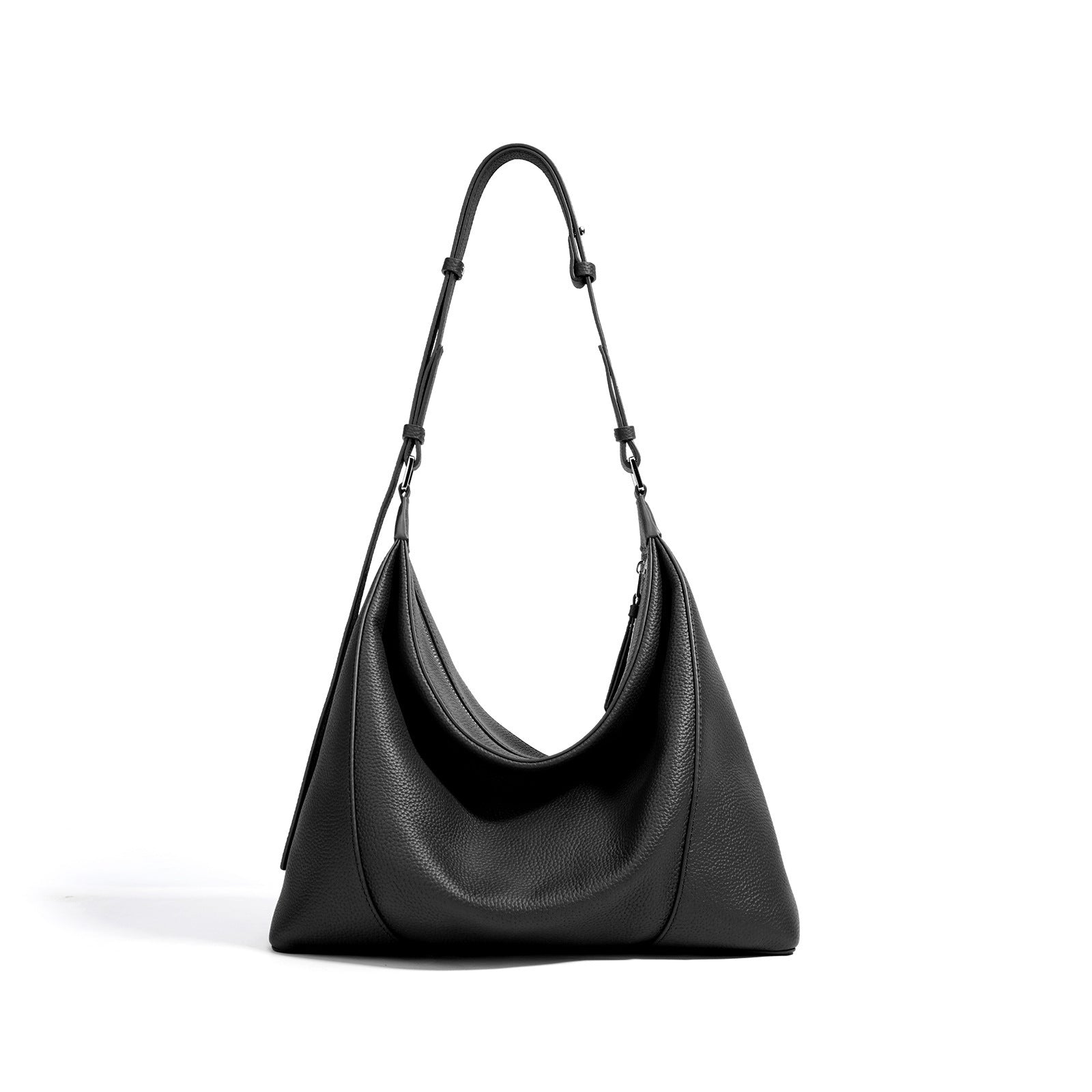 Black handbag with a strap on a white background