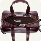 Brown handbag with labeled compartments on a white background