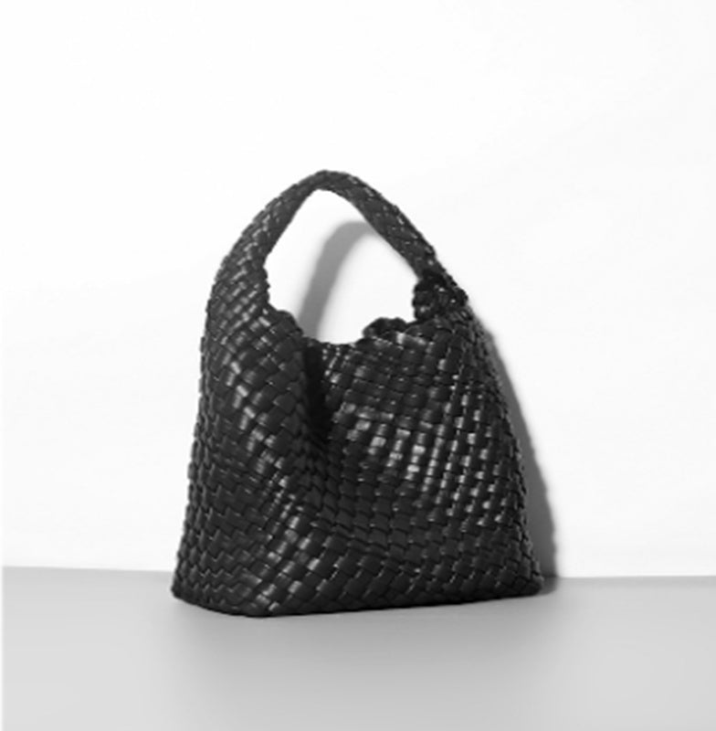 Black woven handbag on a white background