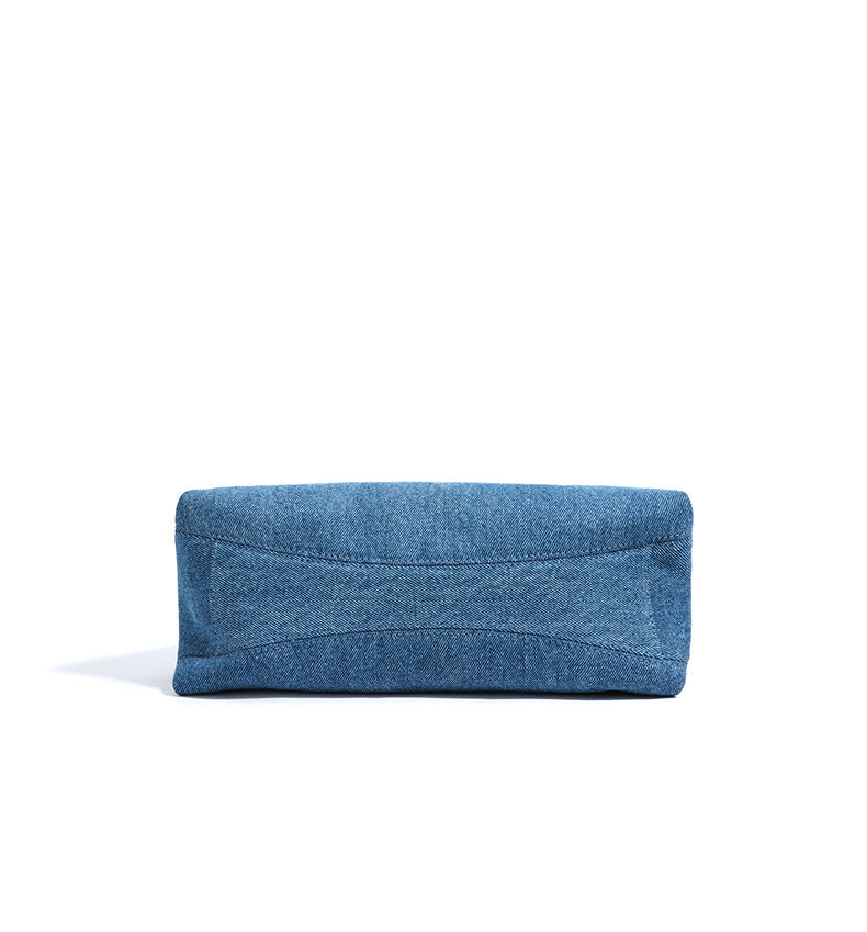 Blue denim clutch bag on a white background