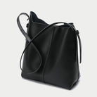 Black leather bucket bag on a light gray background