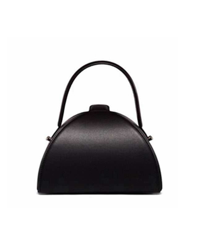 Black handbag with a curved design on a white background