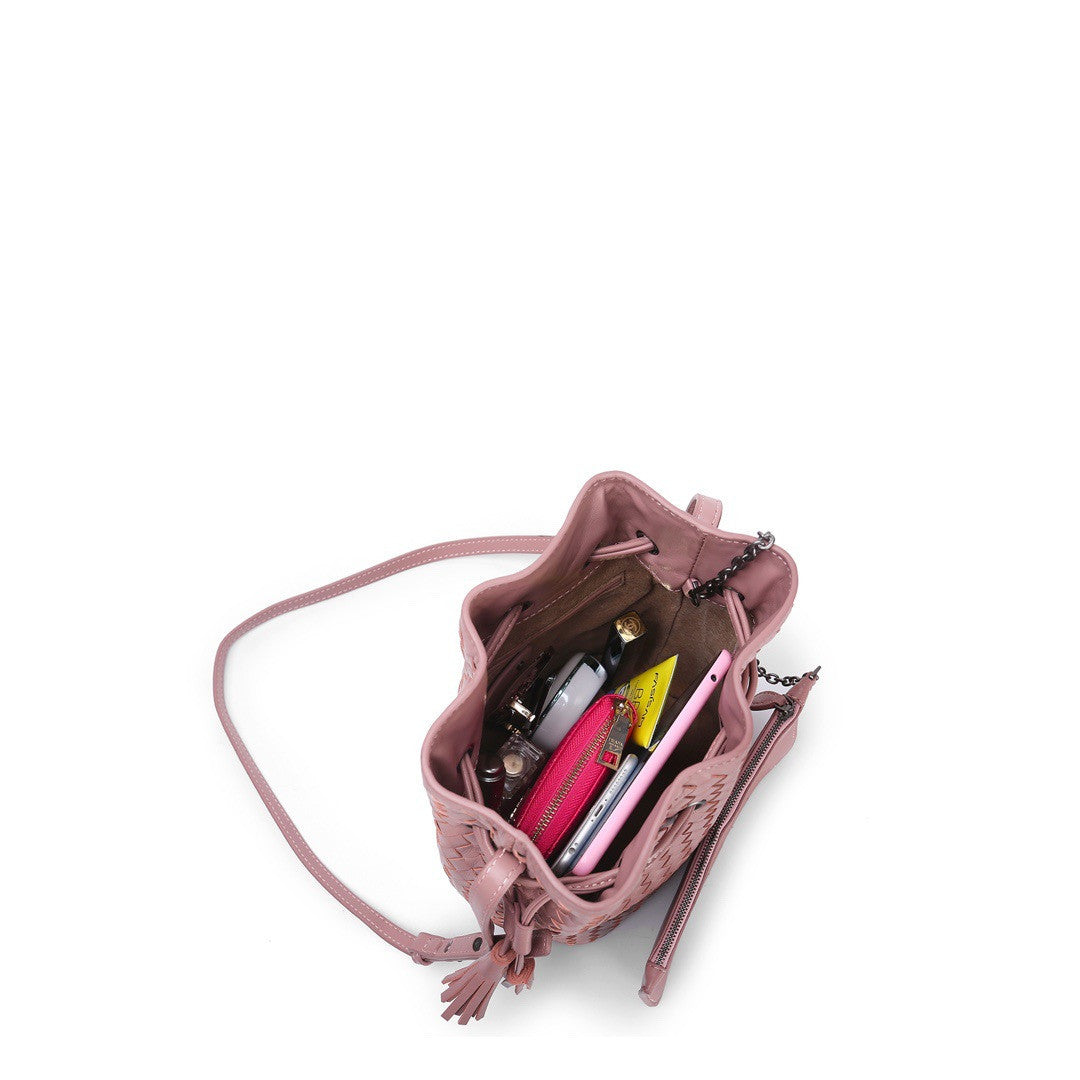 Pink handbag with a shoulder strap on a white background