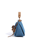 Blue Denim bag with brown leather straps and accents on a white background