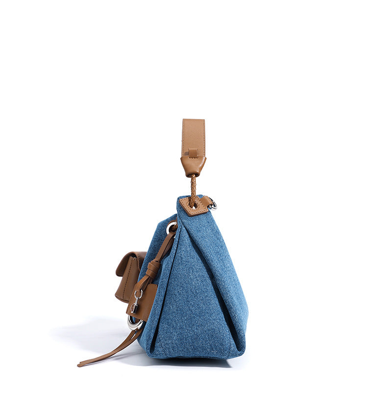 Blue Denim bag with brown leather straps and accents on a white background