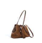 Brown suede handbag with a matching strap on a white background