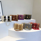 Collection of colorful handbags on a white platform with a neutral background