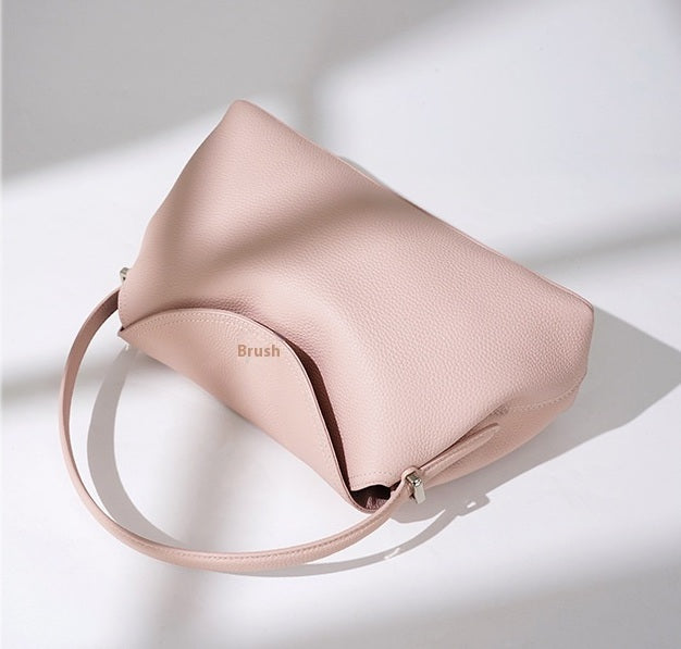 Pink handbag with 'Brush' branding on a light background