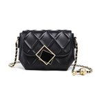 Black quilted handbag with gold accents on a white background