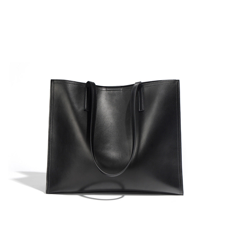 Black leather tote bag on a white background