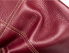Close-up of maroon leather with visible stitching