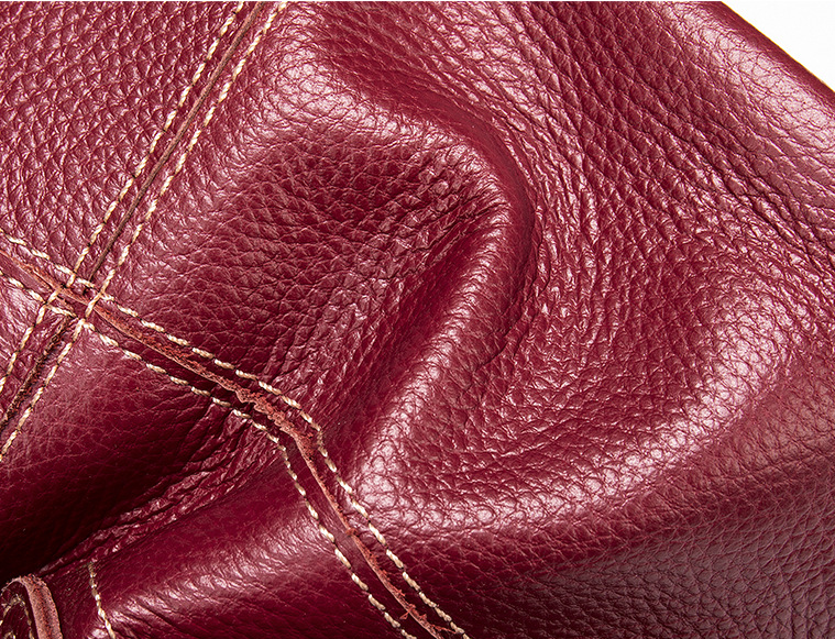 Close-up of maroon leather with visible stitching
