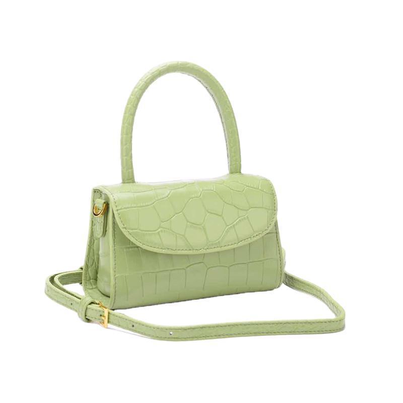 Green handbag with a strap on a white background