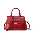 Red handbag with a textured pattern on a white background