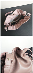 Pink handbag with a strap on a dark surface