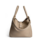 Beige handbag with a visible brand logo on a white background
