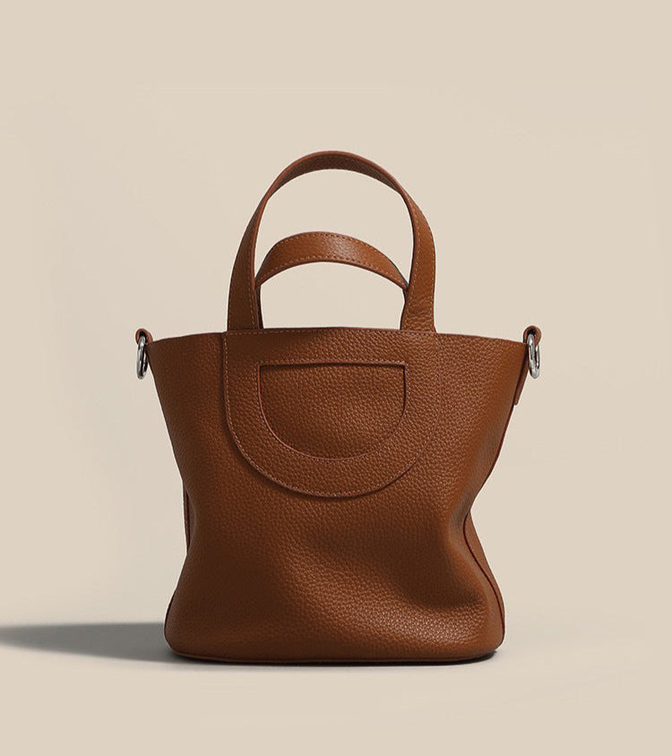 Brown leather handbag on a beige background