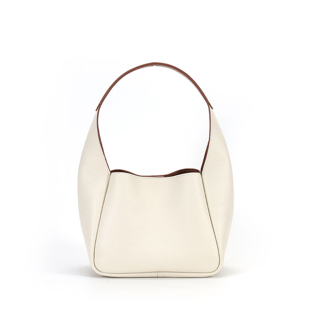 White handbag with brown trim on a white background