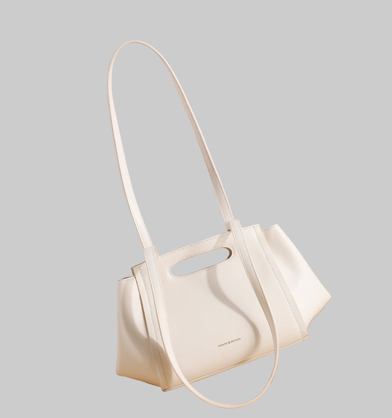 White handbag with a minimalist design on a beige background