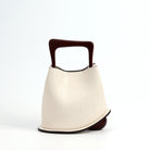 White handbag with a brown handle on a white background
