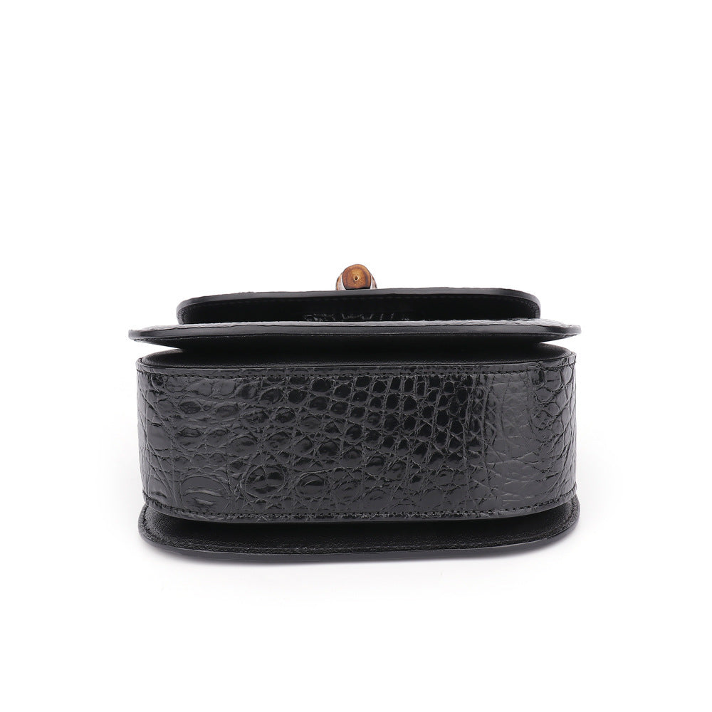 Black textured handbag on a white background