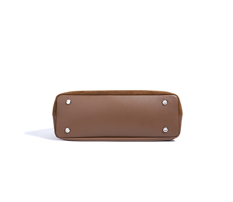 Brown handbag with silver studs on a white background