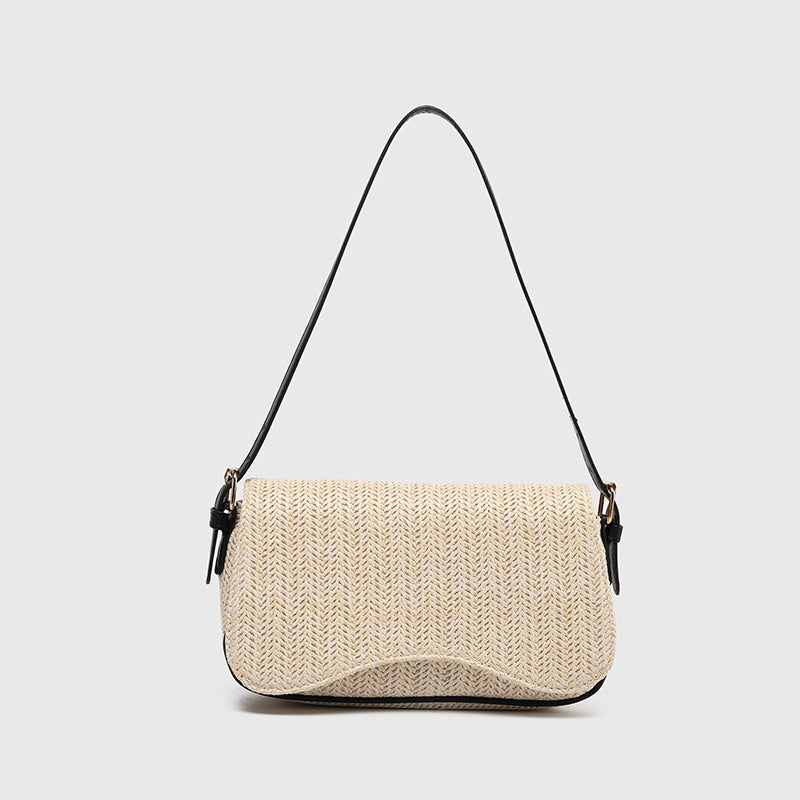 Beige woven handbag with a black strap on a light gray background