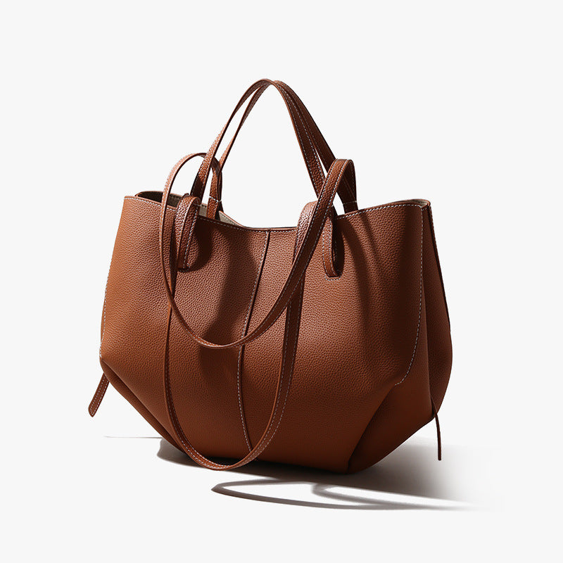 Brown leather handbag on a white background