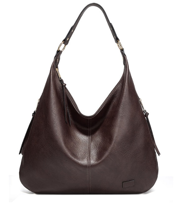Brown leather handbag on a white background