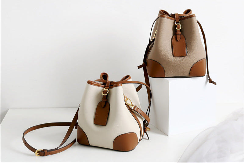 Two beige and brown handbags on a white background