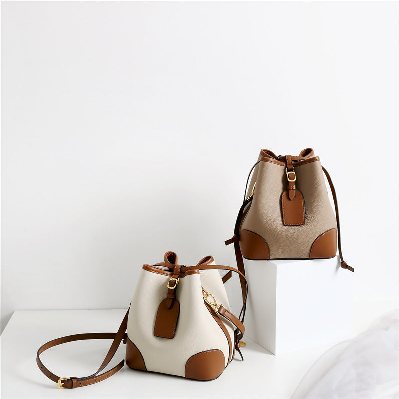Two beige and brown handbags on a white background