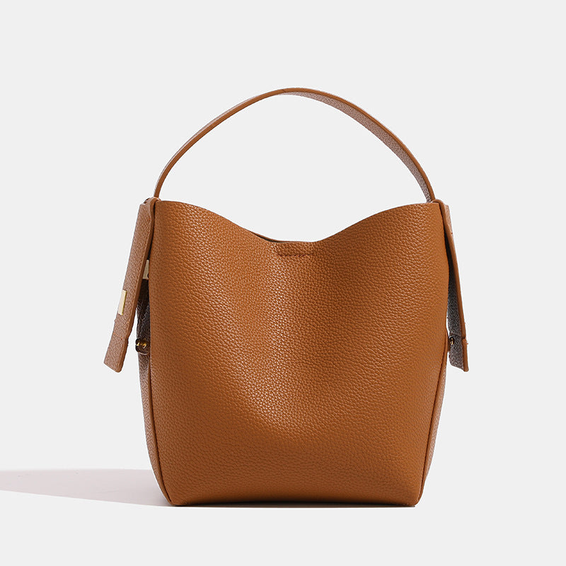 Brown leather handbag on a white background
