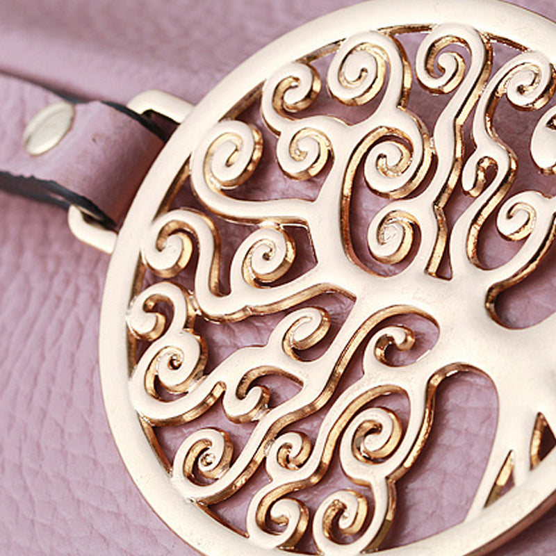 Decorative gold emblem on a pink leather surface