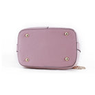 Pink handbag with gold accents on a white background