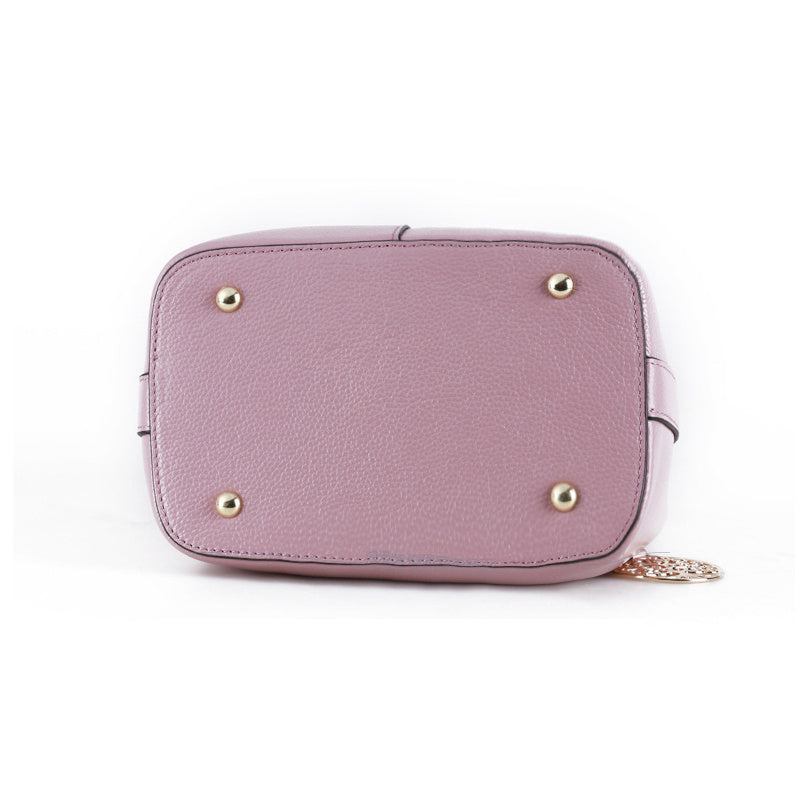 Pink handbag with gold accents on a white background