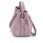 Pink handbag with a strap on a white background