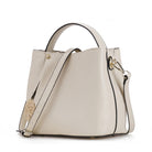 Beige handbag with a shoulder strap on a white background