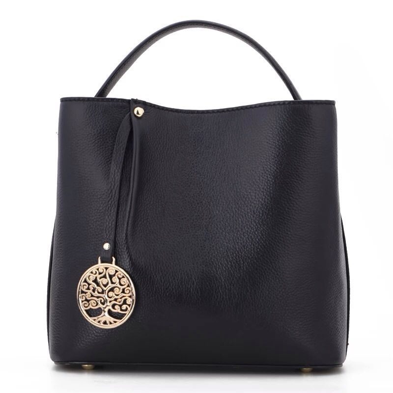 Black handbag with a gold tree of life pendant on a white background