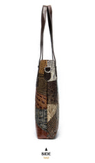 Patterned handbag with a side view on a white background