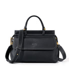 Black handbag with gold accents on a white background