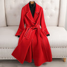 Red coat displayed on a white chair