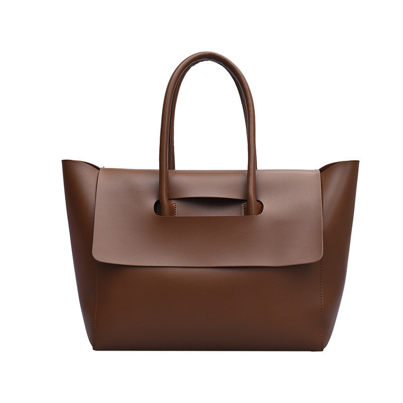 Brown leather handbag on a white background