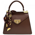 Brown handbag with gold accents and a matching scarf on a white background