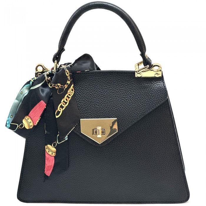 Black handbag with gold accents and colorful charms on a white background