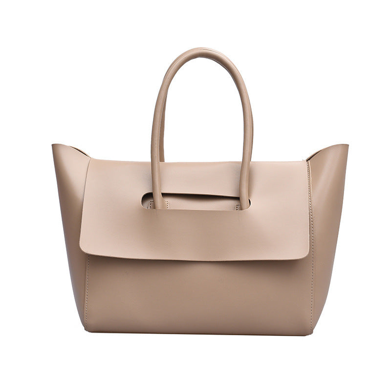 Beige handbag with a handle on a white background